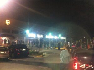 Customers who missed their delivery wait in line for the iPhone 4s