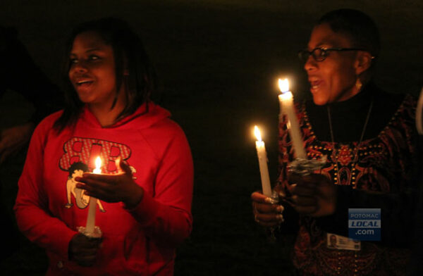 Carlee Jones, 21, of Gainesville, and Tina Murray, of Manassas, remember the shooting victims at Sandy Hook Elementary School at a candlelight vigil in Manassas on Dec. 17. [File photo]