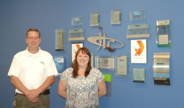 Growing the company out of a small basement to a large office, today John Jewell and Kristen Maxey work to deliver big IT services and small business solutions for JTC, Inc. in Manassas. [Kelly Harman / Potomac Local News]