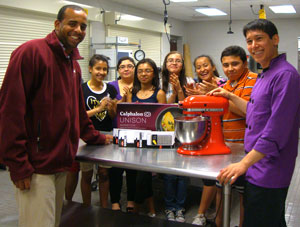 Manassas Park Community Center Recreation Supervisor Tony Thomas and Jason Shriner, The Aubergine Chef, introduce the new equipment to the students who attend cooking classes at the center. [Submitted photo]