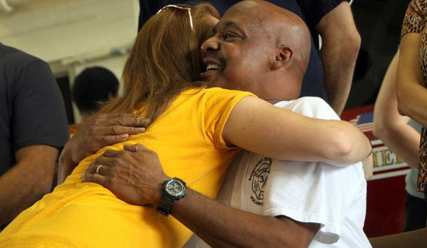 Greeting family and friends one final time, Stanley “Pepper” Johnson hugs one of the many who came to say farewell to the long-serving,terminally ill Dumfries volunteer firefighter. [Photo: Dumfriesfire.com]