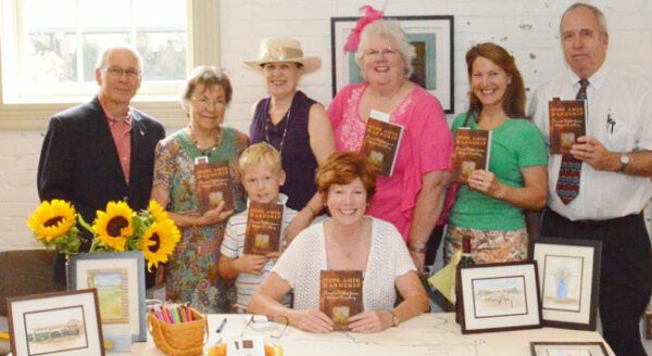 Author Linda S. Johnston (seated, center) is surrounded by her networking friends from Write by the Rails, the Prince William Chapter of the Virginia Writers Club. From left, Bristow author Chip Deyerle (Last Train from Cleveland), Gainesville author June Pair Kilpatrick (Wasps in the Bedroom, Butter in the Well), Bristow author Carol Covin (Who Gets to Name Grandma?) with her grandson Christopher Covin, blogger Jan Rayl, Lake Ridge author Nancy Kyme (Memory Lake) and blogger Dan Verner.