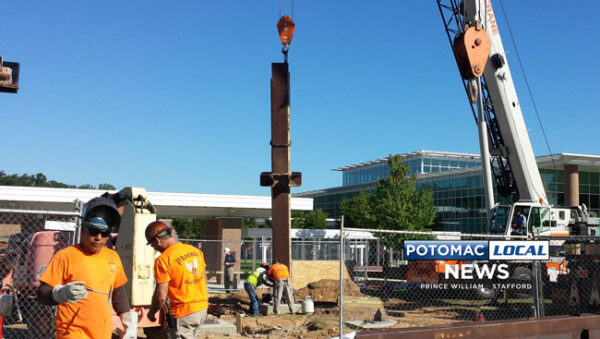 Crews erect steel from the destroyed World Trade Center for a permanent memorial at the Prince William County Government Center in Woodbridge. [Uriah Kiser / Potomac Local News]