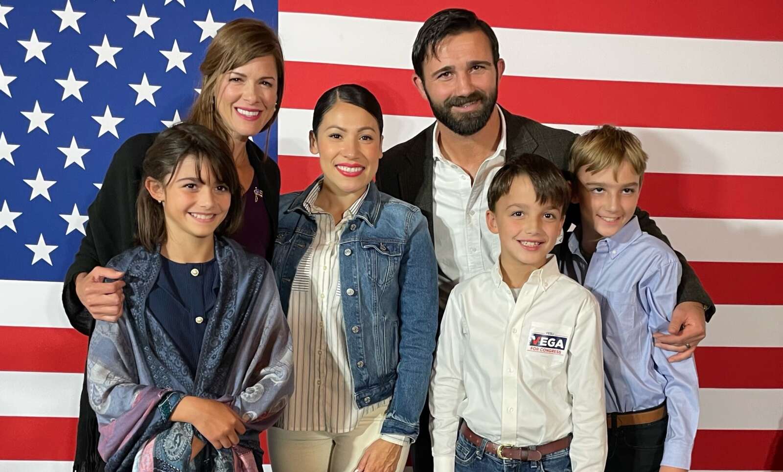 Yesli Vega (center) pictured with Cameron Hamilton (right) and his family.