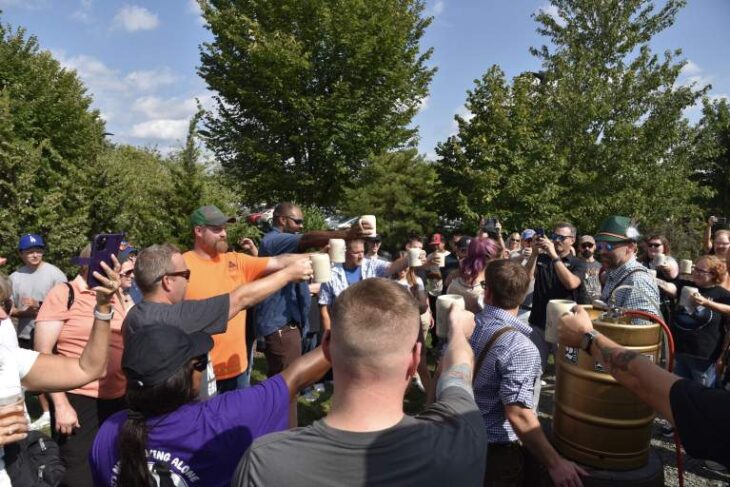 Guests raise steins around a golden keg during Oktoberfest at 2 Silos Brewing Co. in Manassas. Photo courtesy of 2 Silos Brewing Co.
