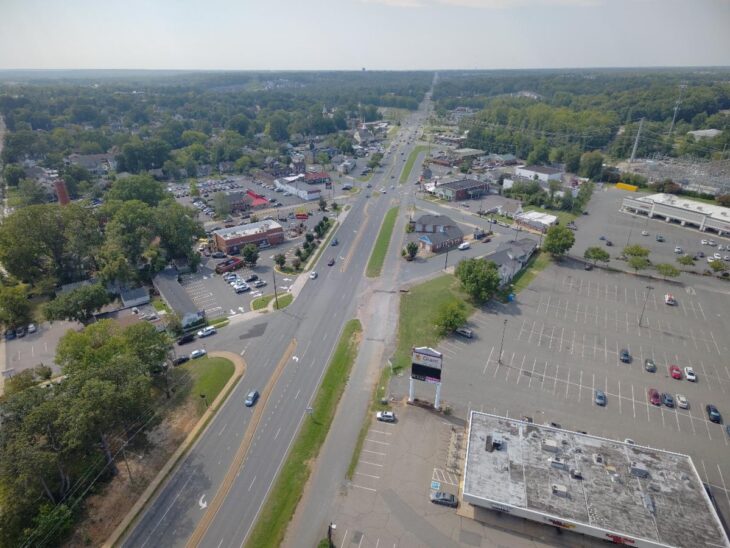 Aerial view of Route 1 in Fredericksburg looking north through the commercial corridor, with a Giant sign and large parking lot on the east side and shops and a McDonald’s on the west side.