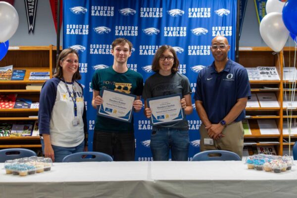 Two Osbourn High School seniors holding National Merit Semifinalist certificates