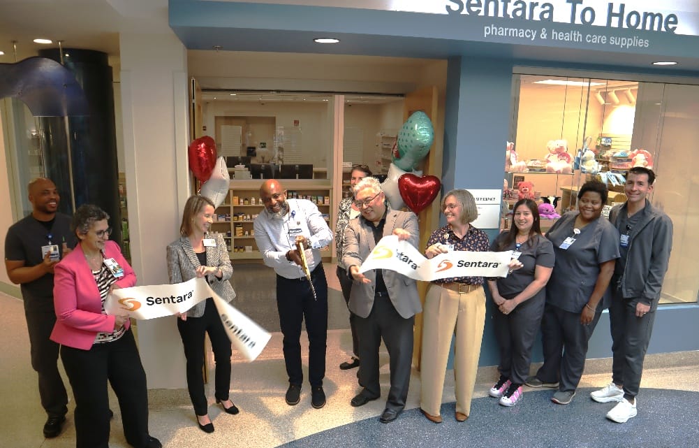 Hospital leaders and the pharmacy team cut the ribbon on the Sentara To Home outpatient pharmacy in Woodbridge.