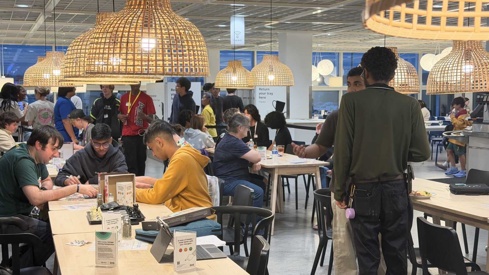Students play games at tables in the IKEA restaurant area during the Oct. 15 event