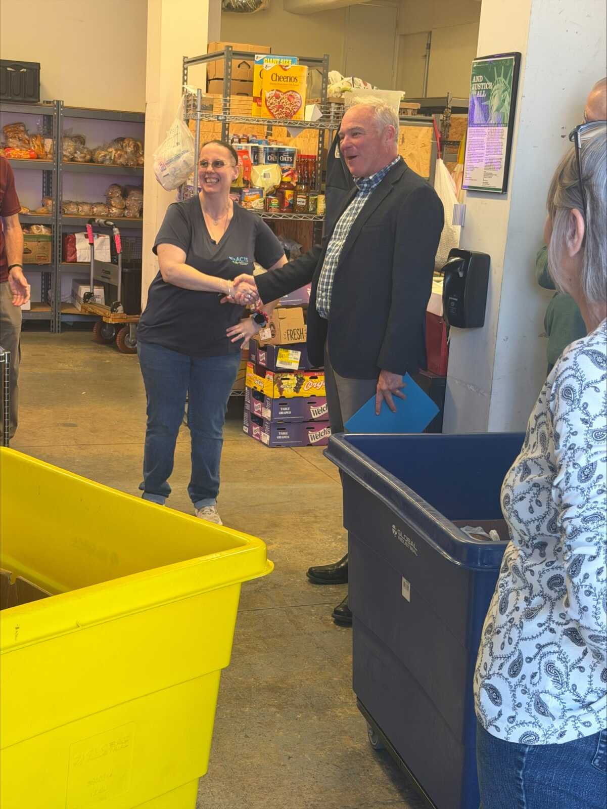 Sen. Tim Kaine greets an ACTS staff member in the food pantry