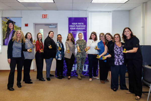 Grand Canyon University and MCCS Quantico staff with Col. Jenny Colegate at the National Testing Center opening