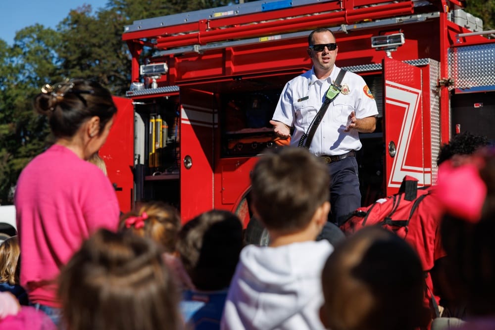 Assistant fire chief Mike Passera talks with children at CDC North