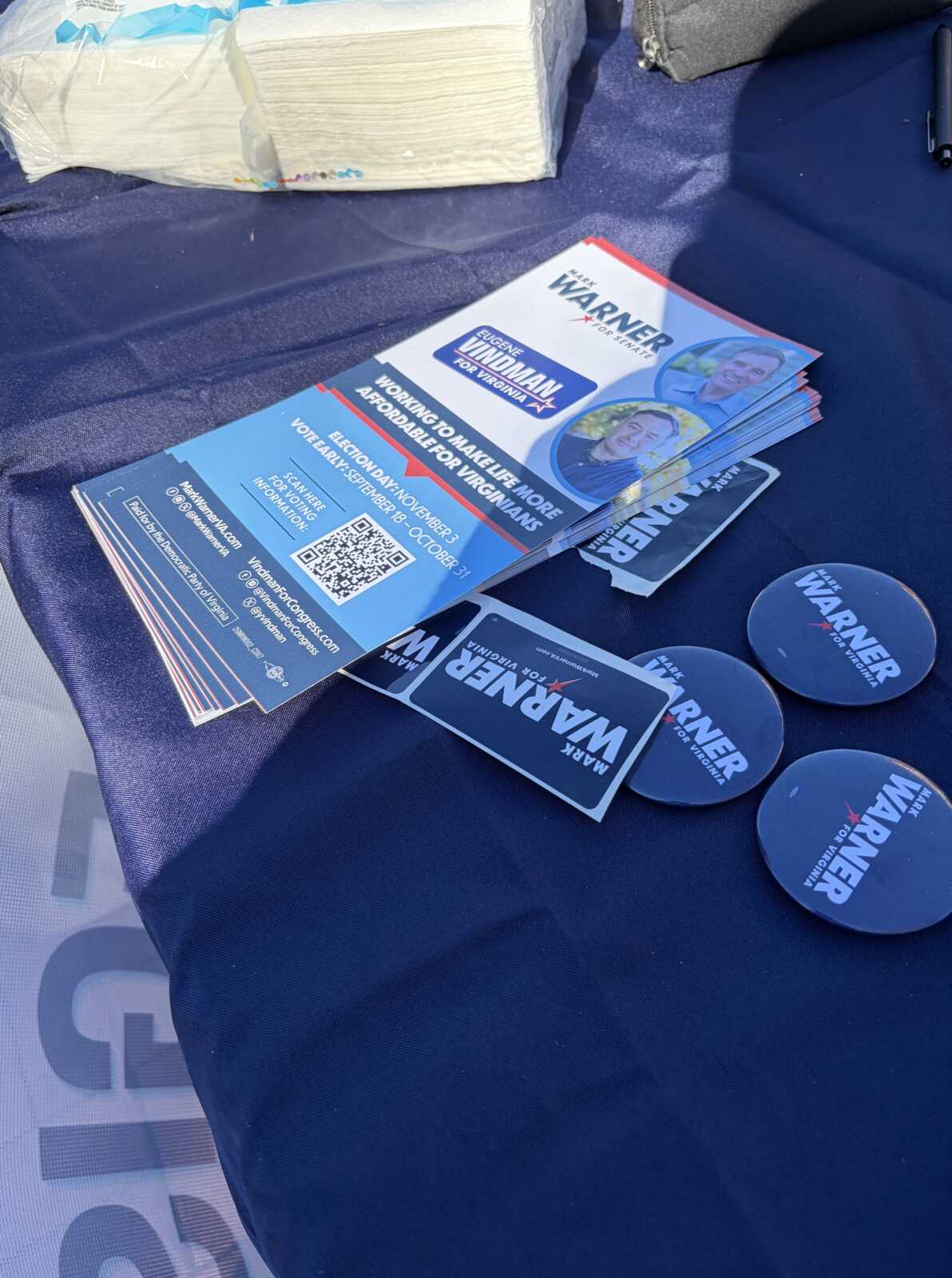 Warner and Vindman campaign literature on a voter registration table at the University of Mary Washington